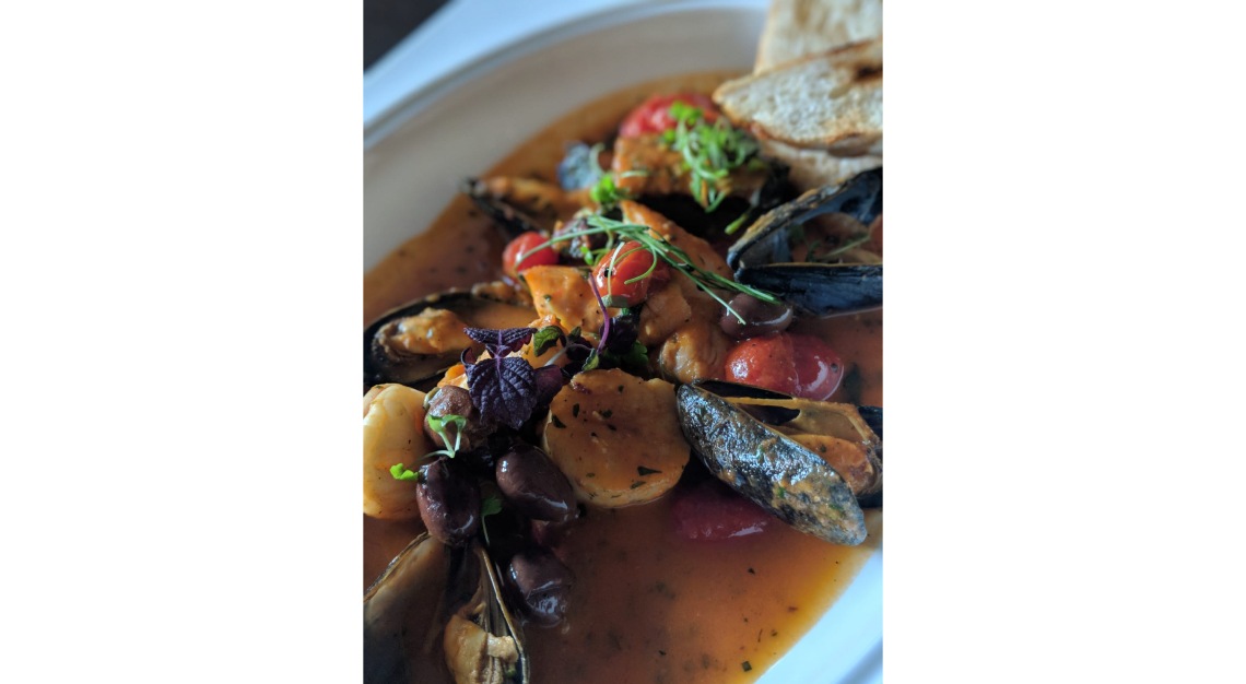 basilico Tuscan-style Seafood Stew with Sea Bass, Salmon, Mussels, Prawns, Scallops, Olives, Fava Beans and Capers