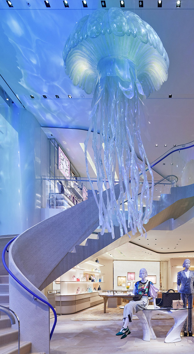 Exterior, the Louis Vuitton Tokyo Omotesando store. Facade is offset panels  of tinted glass behind sheets of metal mesh designed by Aoki Jun. Daytime  Stock Photo - Alamy